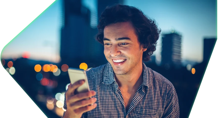 Man on his phone with cityscape in background