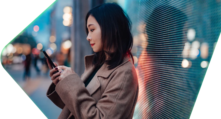 Woman looking at her phone in the city