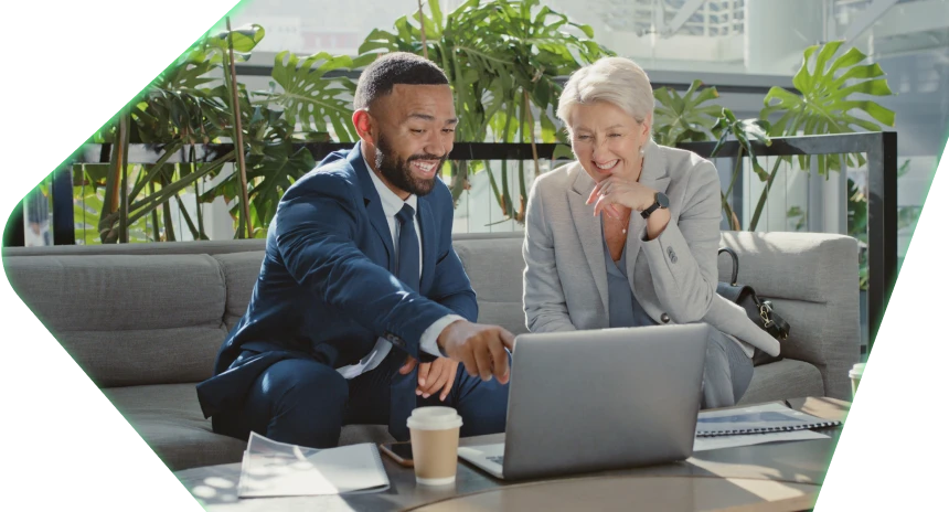 Two people laughing at computer screen