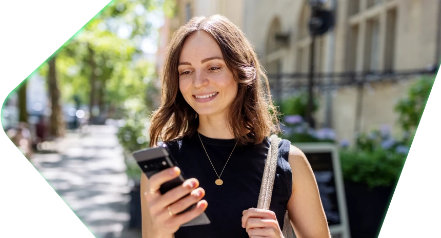 Woman on her device on a walk