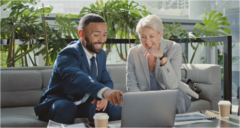 Two people collaborating at a laptop