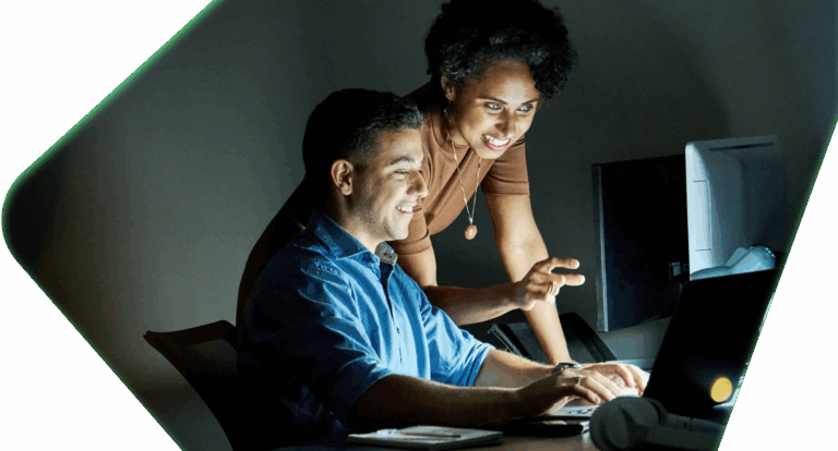 Man and woman working together at computer screen.