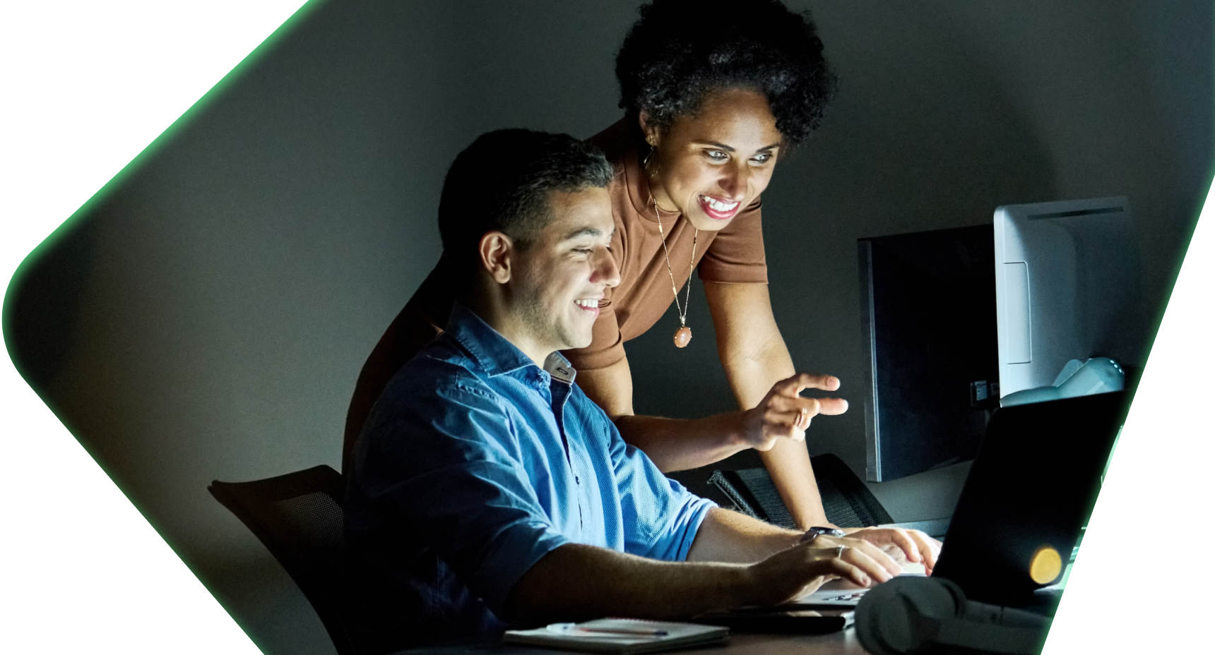 Man and woman working together at computer screen.