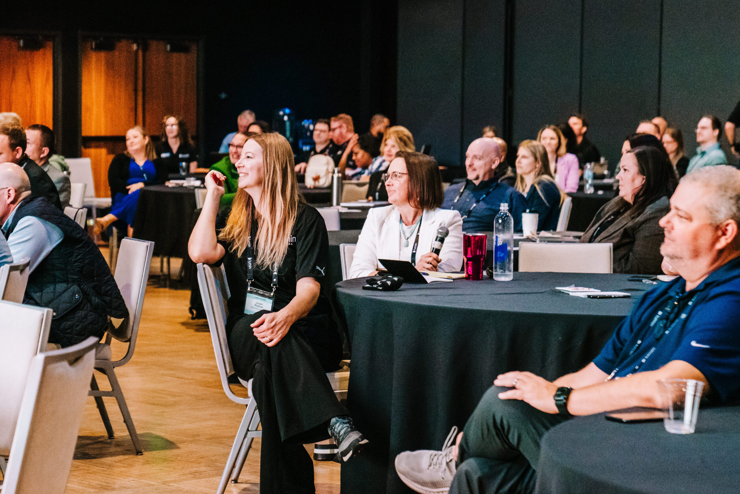 Conference attendees sitting at round tables